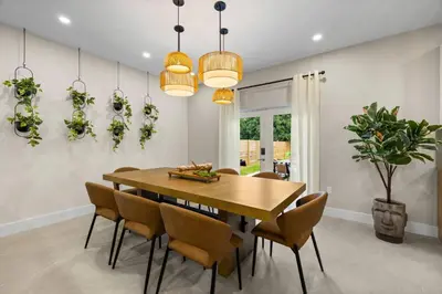 a dining room with a wooden table and chairs at Luxury 4BR Retreat | Pool • Kitchen in Goulds
