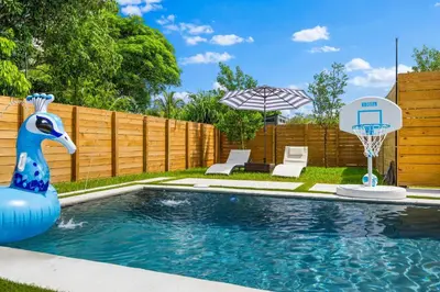 a backyard pool with a basketball hoop and a blue rubber duck in it at Luxury 4BR Retreat | Pool • Kitchen in Goulds