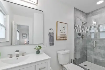a bathroom with a shower and a toilet and a sink at Casa Moderna 3 Bed 2 Bath with Private Patio and BBQ in North Miami Beach