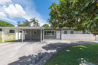 a house with a driveway in front of it at Casa Moderna 3 Bed 2 Bath with Private Patio and BBQ in North Miami Beach