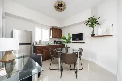a kitchen with a table and a refrigerator at The Donovan in Miami Beach