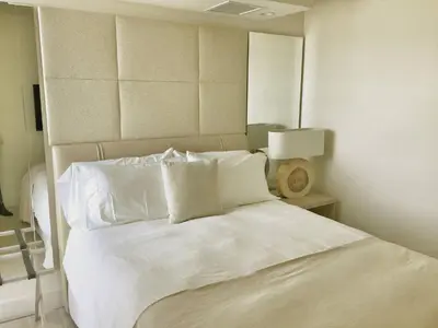 a bedroom with a white bed with white sheets and pillows at Amazing View 1 Hotel Corner Unit 2BR/2BA w Balcony in Miami Beach