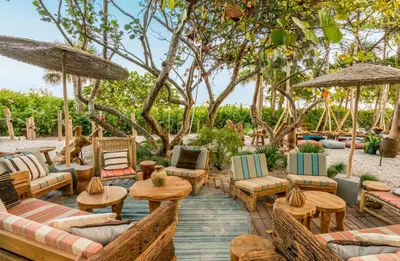 a patio with chairs and tables and umbrellas at Amazing View 1 Hotel Corner Unit 2BR/2BA w Balcony in Miami Beach