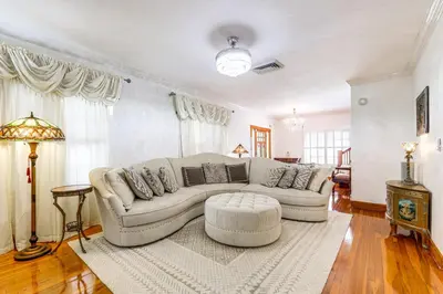 a living room with a couch and a table at Walk to Las Olas! Old Florida Oasis with Hot Tub in Fort Lauderdale