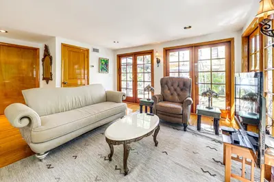 a living room with a couch and a table at Walk to Las Olas! Old Florida Oasis with Hot Tub in Fort Lauderdale