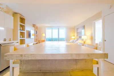 a dining room with a large table in a room at Amazing View 1 Hotel Corner Unit 1BR/1BA w Balcony in Miami Beach