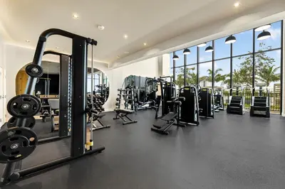 a gym with several treadmills and weights at Condo at 72 Park - Miami Beach Area & Resort Facilities in Miami Beach