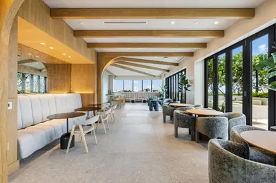 a restaurant with tables and chairs and windows at Resort & Beach - The Ideal Condo at 72 Park in Miami Beach