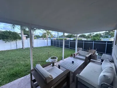 a screened in patio with a table and chairs at Place to stay in Hallandale Beach