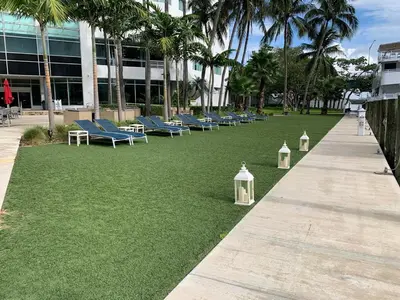 a row of chairs on the grass in front of a building at Ocean Breeze Condo - Intracostal and Ocean views at GalleryOne in Fort Lauderdale