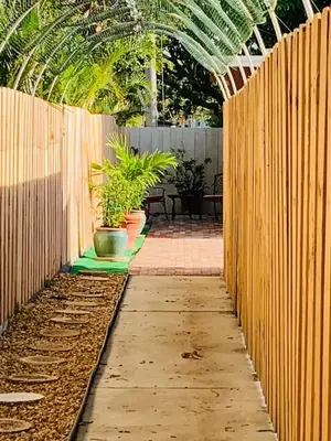 a garden with a wooden fence and potted plants at Zen Garden Studio in Hollywood