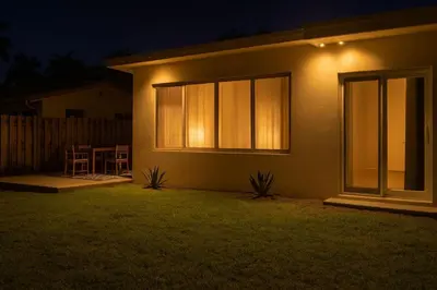 a house with lights on the side of it at night at Positano Ville I Waterfront and Grill I 10 min Beach in Fort Lauderdale