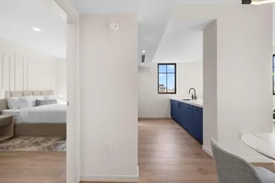 a white bedroom with a bed and a sink at The Avenue Hotel Coral Gables in Miami
