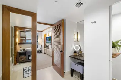 a hallway of a hotel room with a bathroom at Skyline View Private Residence at Carillon Resort - 705 in Miami Beach
