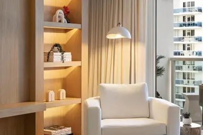 a white chair in a room with a window at Oceanview Private Residence at 1 Hotel and Homes - 1202 in Miami Beach
