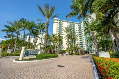 a large building with palm trees in front of it at The Azul Beachview Get away in Hollywood