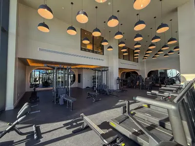 a gym with a bunch of treadmills and machines at Luxury View-Walk to beach! in Miami Beach