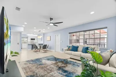 a living room with a couch and a table at Las Olas & Beachside getaway with pool in Fort Lauderdale