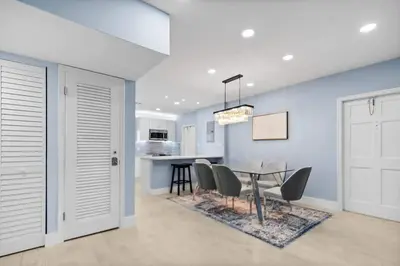 a kitchen and dining room with a table and chairs at Las Olas & Beachside getaway with pool in Fort Lauderdale