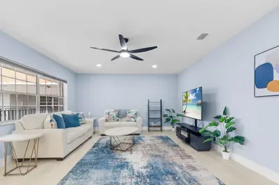 a living room with a couch and a ceiling fan at Las Olas & Beachside getaway with pool in Fort Lauderdale