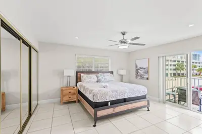 a bedroom with a bed and a ceiling fan at Beach Pool & Las Olas Getaway Fort Lauderdale in Fort Lauderdale