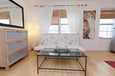 a living room with a couch and a glass table at Best Location In South Beach Steps To Everything! in Miami Beach