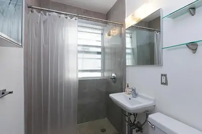 a bathroom with a shower and a sink at Best Location In South Beach Steps To Everything! in Miami Beach