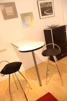 a table and two chairs in a room at Best Location In South Beach Steps To Everything! in Miami Beach