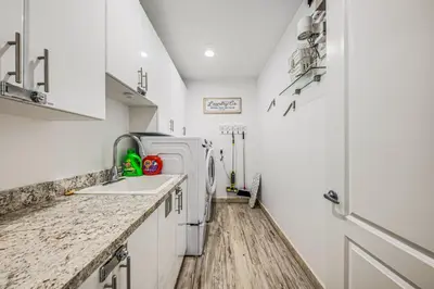 a white kitchen with a sink and a refrigerator at Walk to Hollywood Beach Luxury Family Getaway! in Hollywood