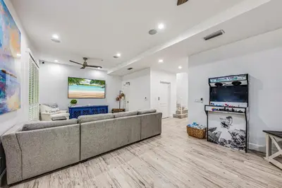 a living room with a couch and a flat screen tv at Walk to Hollywood Beach Luxury Family Getaway! in Hollywood