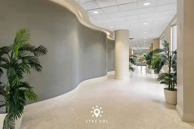 a hallway with two palm trees in a building at Modern Hollywood Beach Escape - City Views in Hollywood