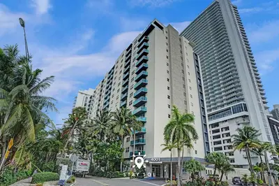 a large building with palm trees in front of it at Modern Hollywood Beach Escape - City Views in Hollywood