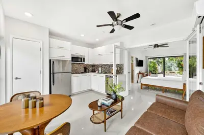 a kitchen and living room with a couch and a table at Sleek Kitchenette & Queen Bed in Fort Lauderdale