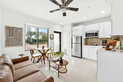 a living room with a couch and a table at Sleek Kitchenette & Queen Bed in Fort Lauderdale
