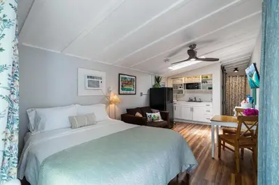 a bedroom with a bed and a living room at Jungle Fortress in Fort Lauderdale