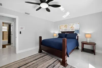 a bedroom with a blue bed and a ceiling fan at 2BR Home Near Wilton Manors & Downtown in Fort Lauderdale