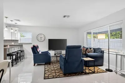 a living room with two blue chairs and a tv at 2BR Home Near Wilton Manors & Downtown in Fort Lauderdale