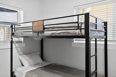 a bunk bed in a room next to a window at 2BR Home Near Wilton Manors & Downtown in Fort Lauderdale
