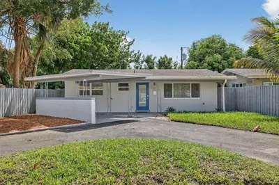 a house with a fence in front of it at 2BR Home Near Wilton Manors & Downtown in Fort Lauderdale