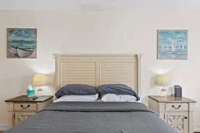 a bedroom with a large bed with two night stands at Beachside Las Olas Getaway Oasis with Pool in Fort Lauderdale