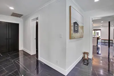 a room with a white wall and a picture on the wall at Coral Lane by Rove Travel - Home with Pool & BBQ in Fort Lauderdale