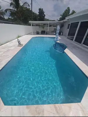 a large blue swimming pool in front of a house at Miami Lifestyle, Modern, Private heated Pool, BBQ in North Miami Beach
