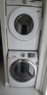 a dryer and a washing machine in a room at Miami Lifestyle, Modern, Private heated Pool, BBQ in North Miami Beach