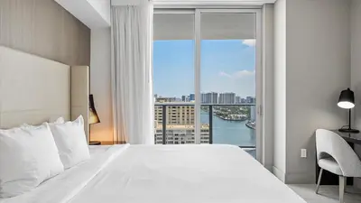 a bedroom with a large white bed and a large window at Hyde House in Hollywood
