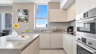 a white kitchen with a sink and a window at Hyde House in Hollywood