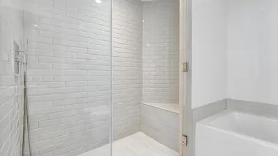 a shower with a glass door next to a bath tub at Hyde House in Hollywood