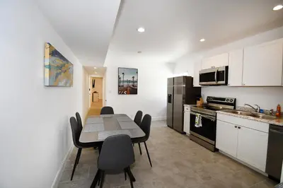 a kitchen with a table and chairs in a room at Coastal Collection in Fort Lauderdale