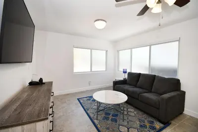 a living room with a couch and a table at Coastal Collection in Fort Lauderdale