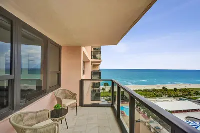 a balcony with a view of the beach and the ocean at Modern 3BR Ocean view Condo with Pools, Gym and Sauna 1407 in Miami Beach