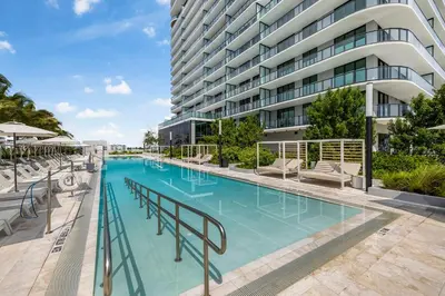 a large swimming pool in front of a building at 72 Park Condo - City Views & Prime Location in Miami Beach